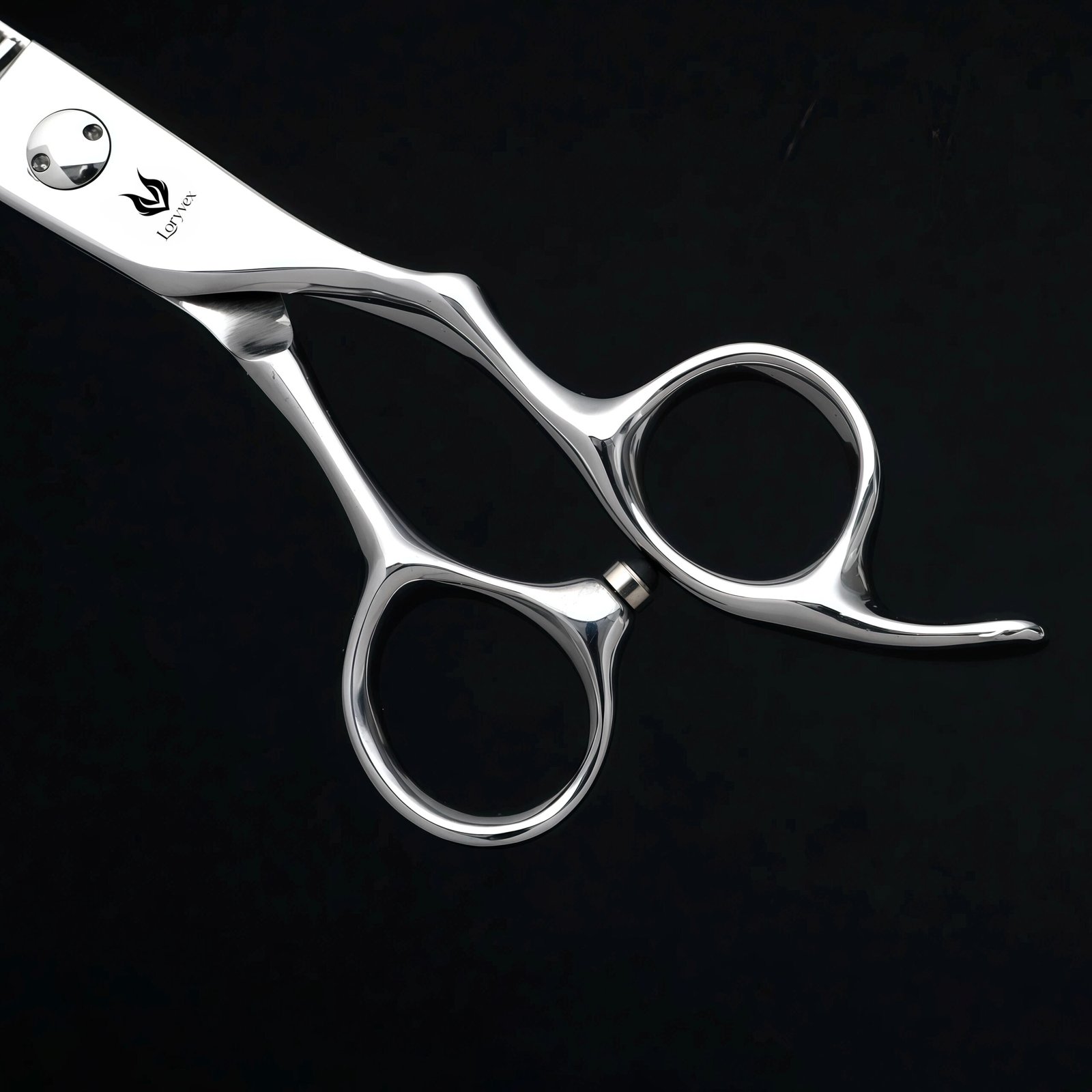 Offset handle and finger rest detail on polished silver hairdressing shears